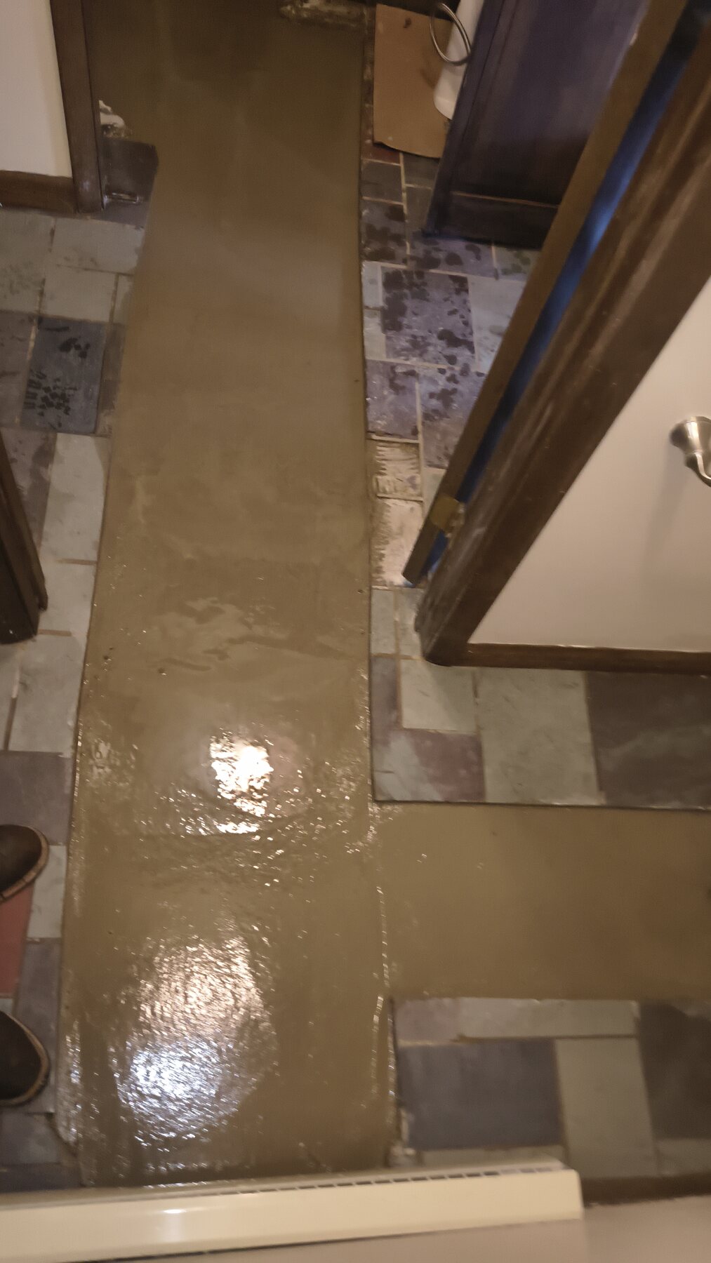 Plumbing-access floor restoration: After — surface restored