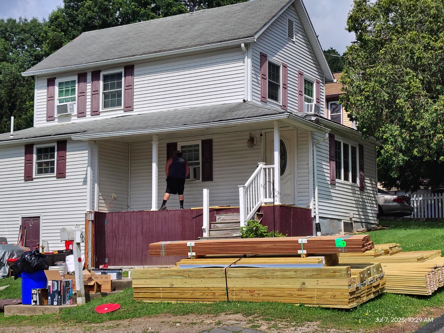 Front porch before controlled removal with replacement framing materials staged on site
