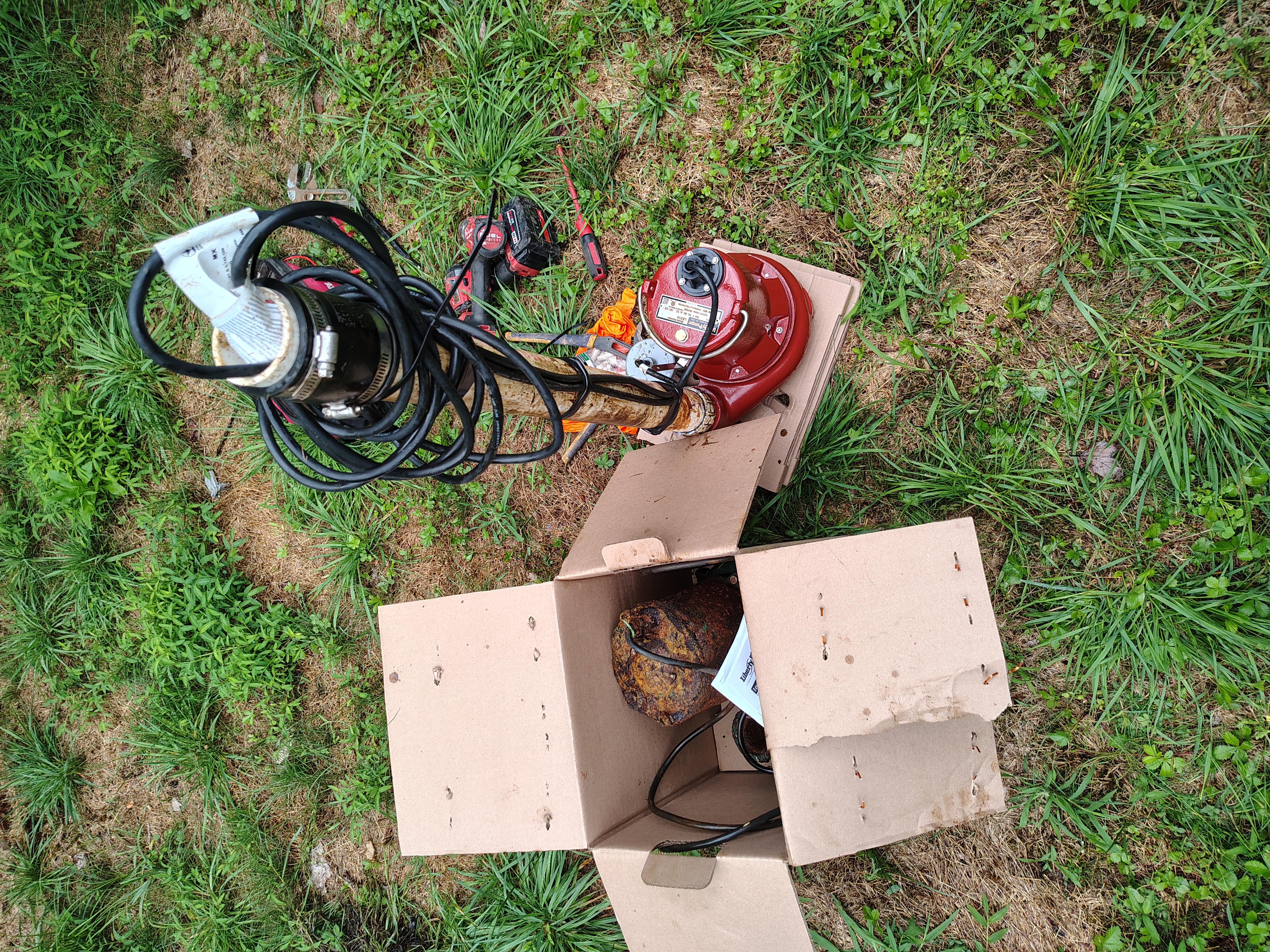 Failed septic pump in a box beside the replacement pump before installation in Waverly Pennsylvania